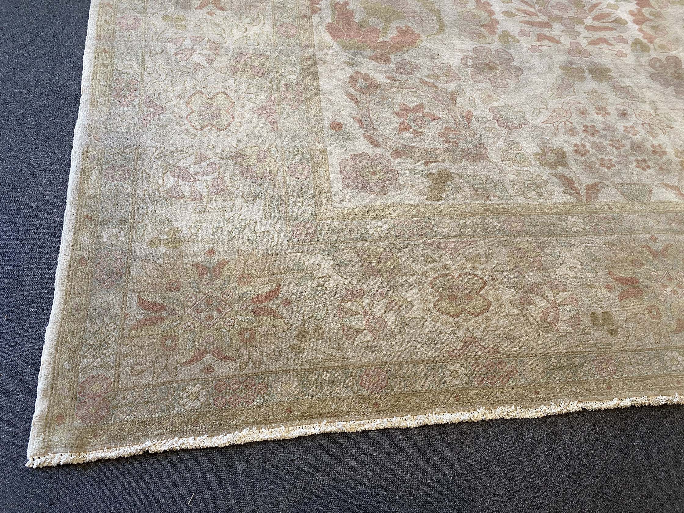 A large Indian ivory ground carpet, 445 x 372cm